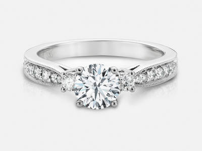 The Trista style engagement ring set with 16 round brilliant cut side diamonds features a 0.44 carat GIA certified round brilliant center, I color, SI1 clarity.  $4440.00